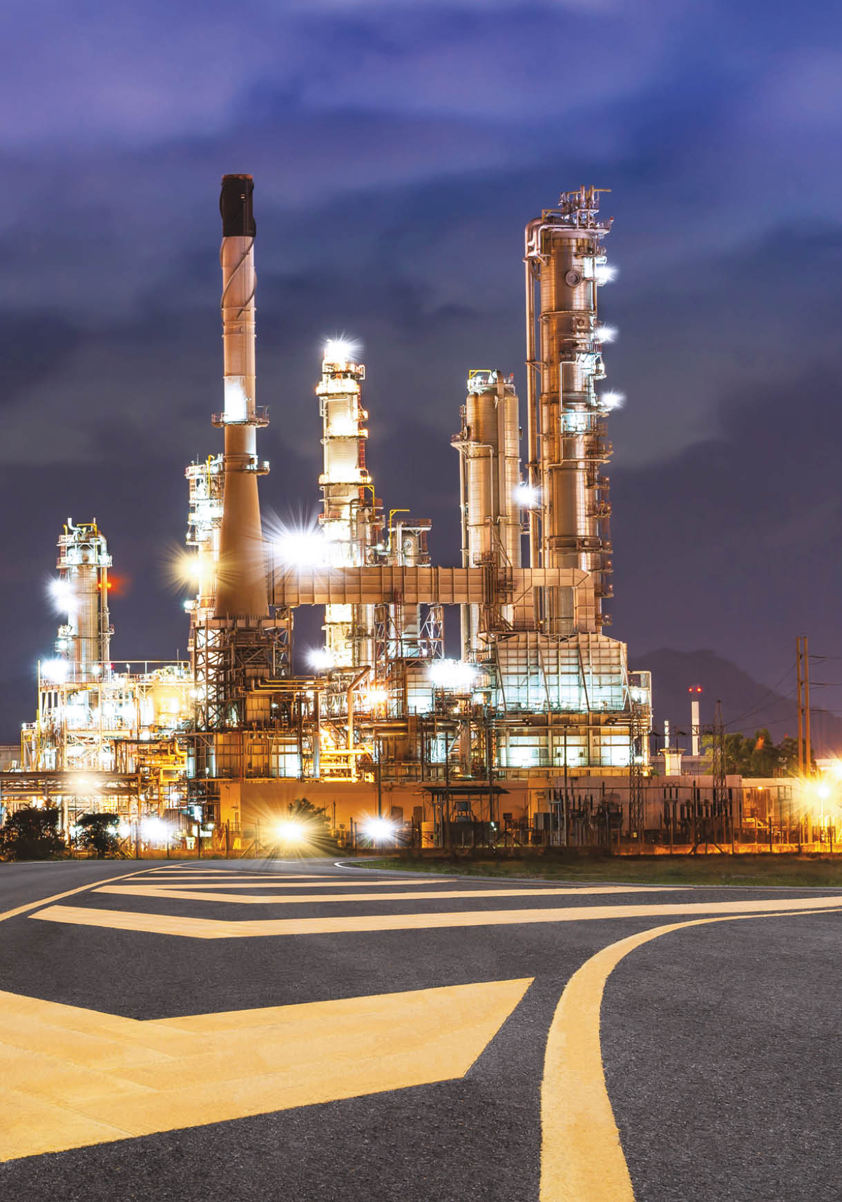 Road to the oil refiner on blue sky in sunset time