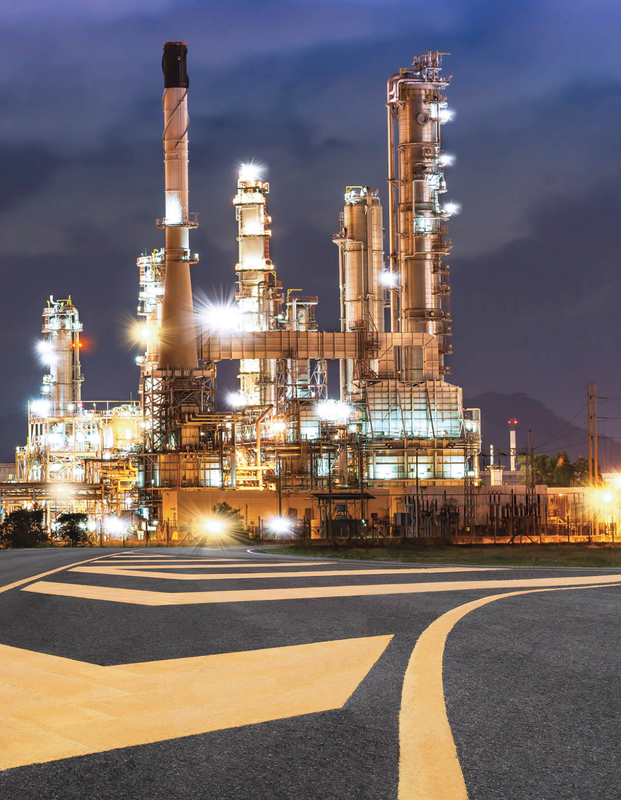 Road to the oil refiner on blue sky in sunset time